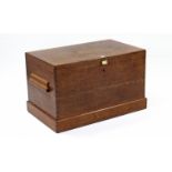 A large oak blanket box with hinged lift lid, moulded oak side handles & on plinth base (lock