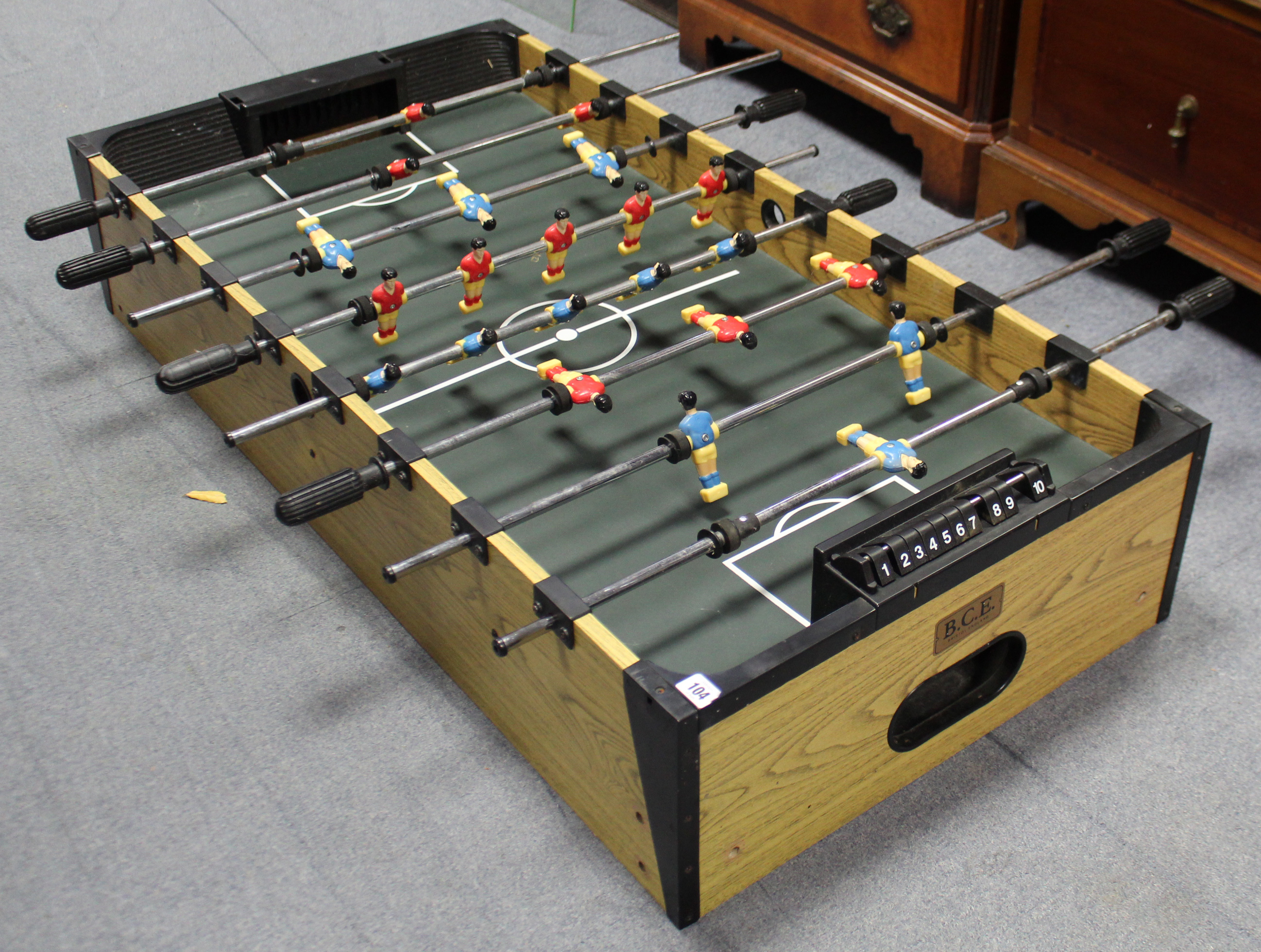 A B.C.E. table football game on square legs, 4’ x 2’.