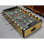 A B.C.E. table football game on square legs, 4’ x 2’.