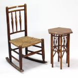 An ash spindle-back rocking chair with woven rush seat, & on round tapered legs with spindle