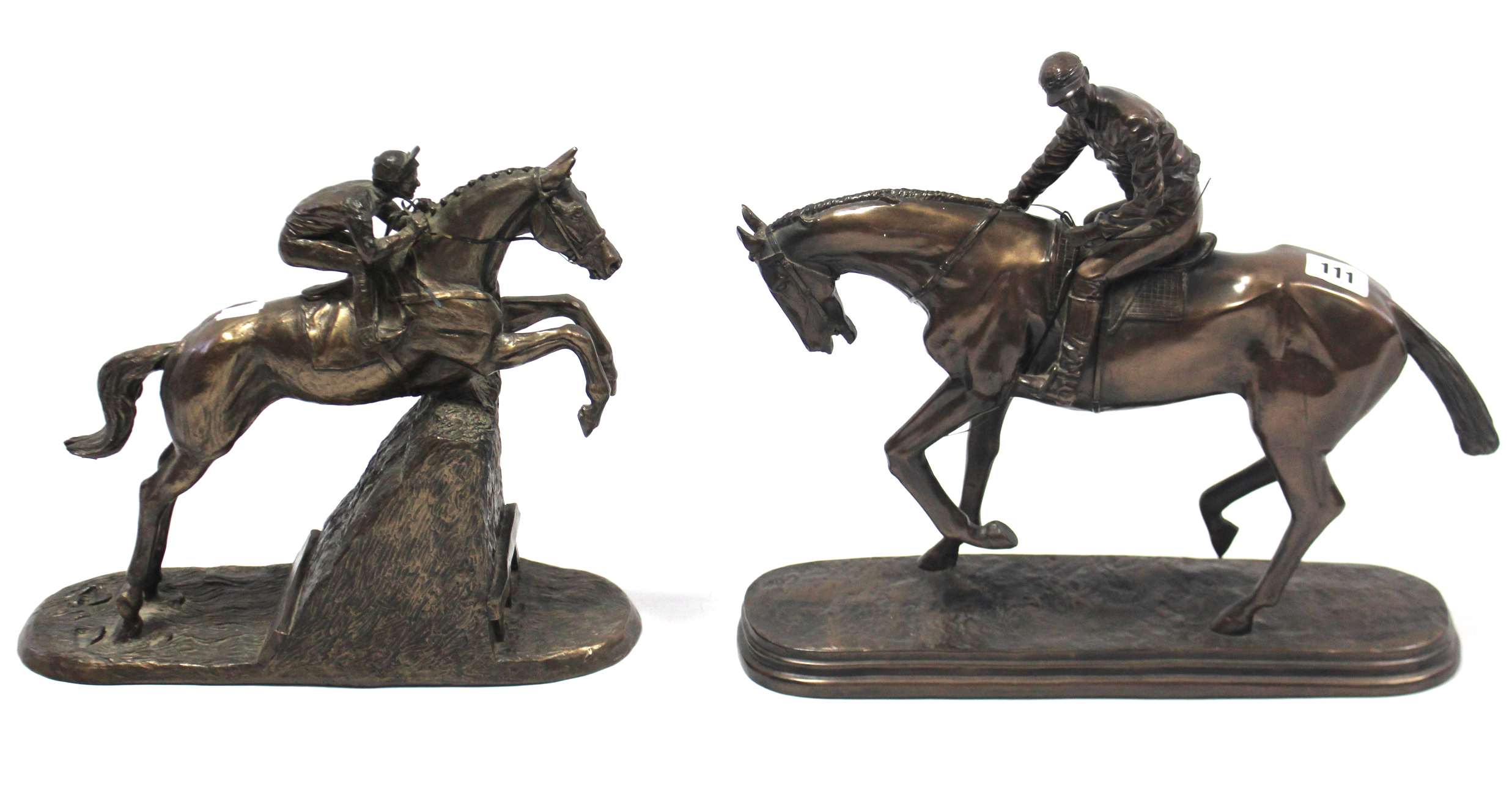 Two bronzed resin ornaments, each in the form of a racehorse with jockey up.