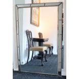 A large rectangular wall mirror in silvered-finish frame & with segmented mirrored border, 55” x