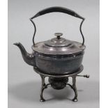A plain round tea kettle on spirit burner stand; 10½” high.