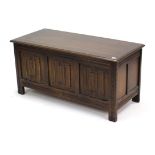 A reproduction oak blanket box with hinged lift-lid, & with linen-fold panel front, 41½” wide.
