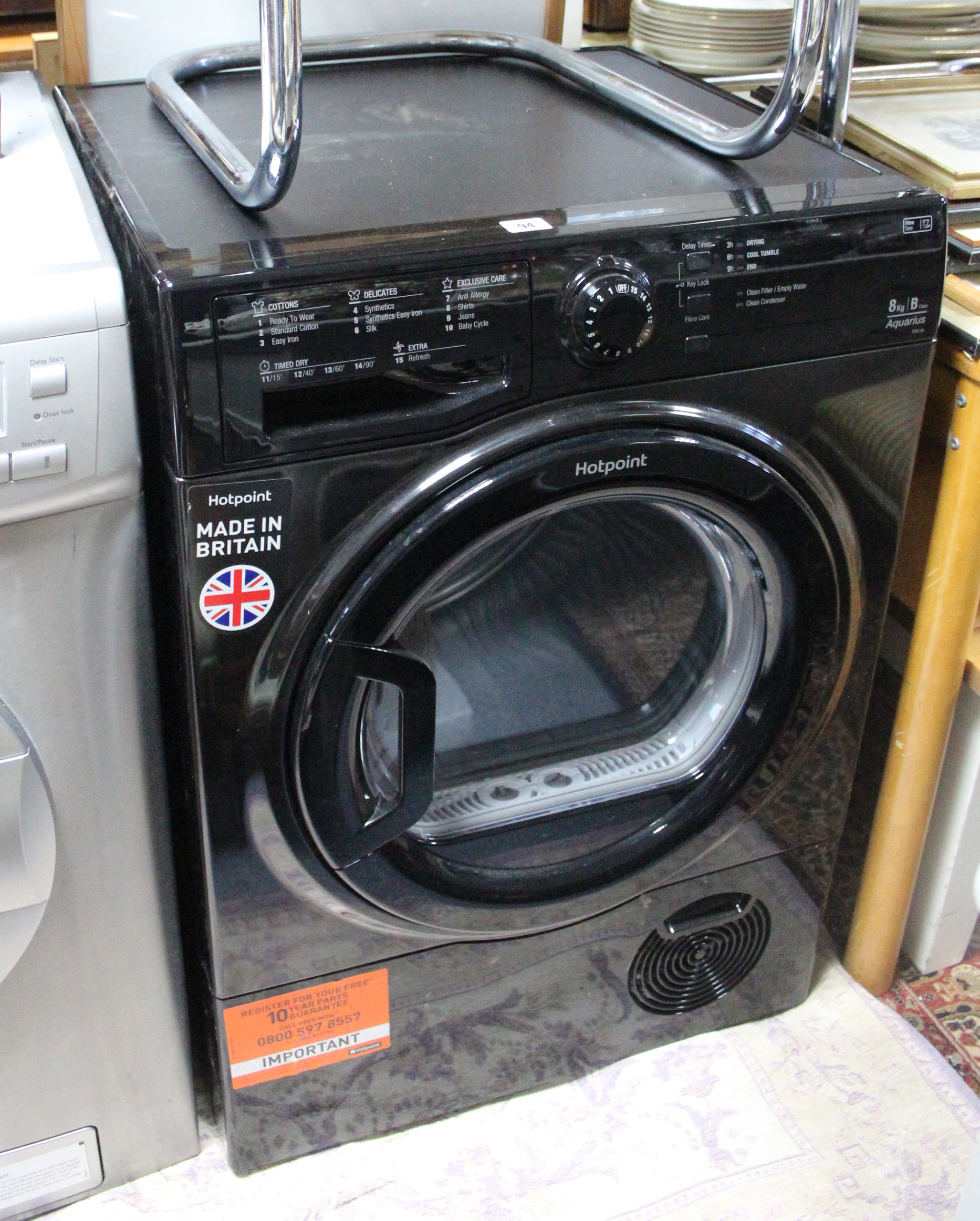 A Hotpoint “Aquarius” 8kg tumble-dryer in black-finish case.