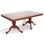 A mahogany-finish dining room suite comprising of an extending twin pedestal table with two