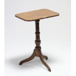 A 19th century oak tripod table with rounded corners to the rectangular tilt-top, & on vase-turned