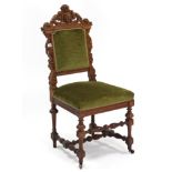 A late 19th/early 20th century carved oak hall chair with padded back & sprung seat upholstered