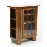 A walnut & carved oak small cabinet fitted two shelves enclosed by a glazed door, with open