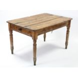 A Victorian pine kitchen table with rounded corners to the rectangular top, fitted end drawer, &