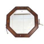 A 1930’s oak frame octagonal wall mirror with beaded edge & inset bevelled plate, 25¼” wide.