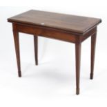 A 19th century inlaid-mahogany tea table with moulded edge to the rectangular fold-over top, & on