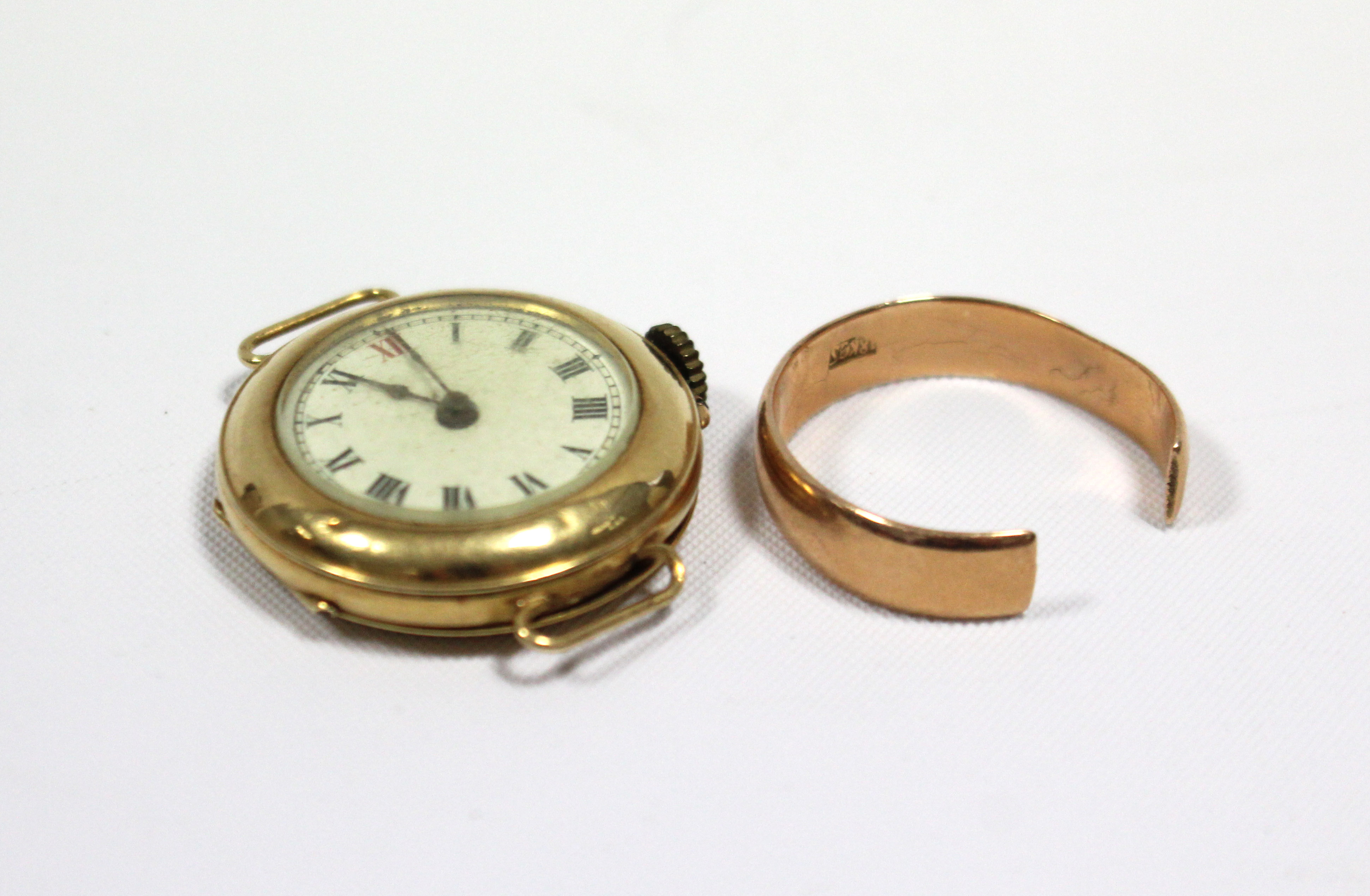 A yellow-metal wedding band stamped “18k”; & an 18ct. gold-cased ladies’ wristwatch, lacking strap.