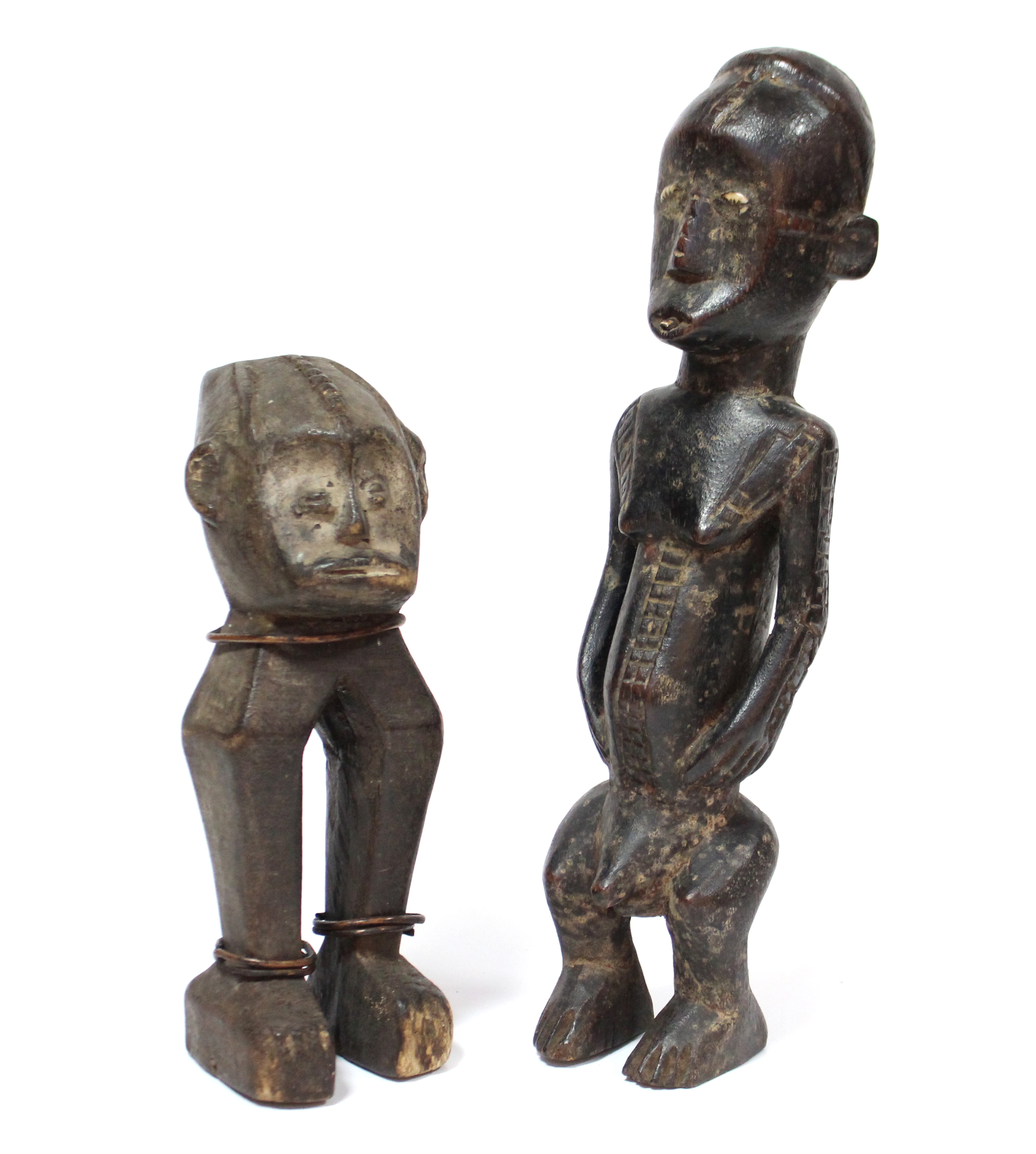 A carved wood standing figure inset cowrie-shell eyes, possibly Ugbandi or Ngbaki, 11¾” high; & a