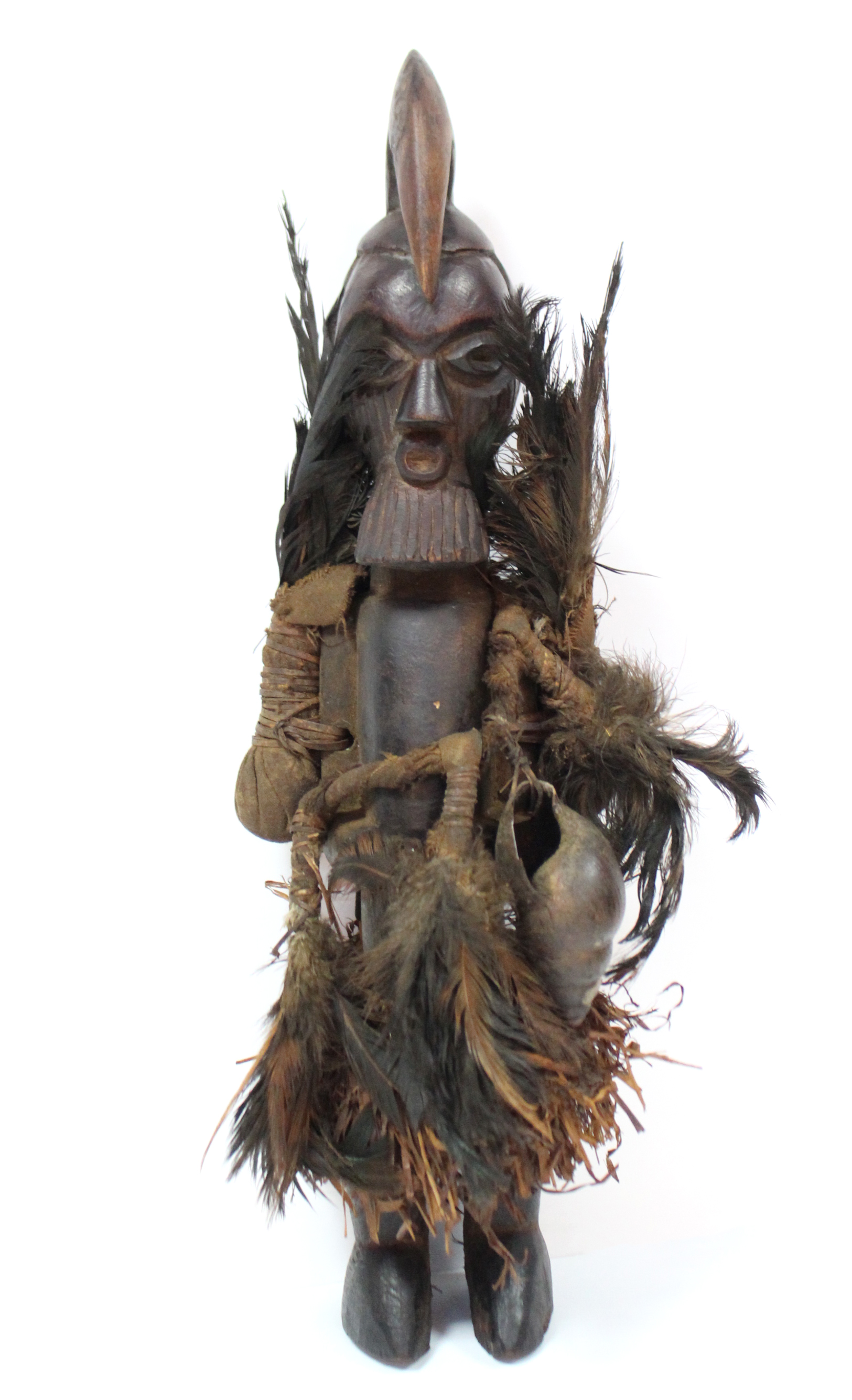 A Teke fetish figure with speer-shaped head-piece & scarified face, pouches of feathers either side,