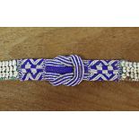 A Kuba woven raffia belt with three rows of applied cowrie shells either side of a blue & white