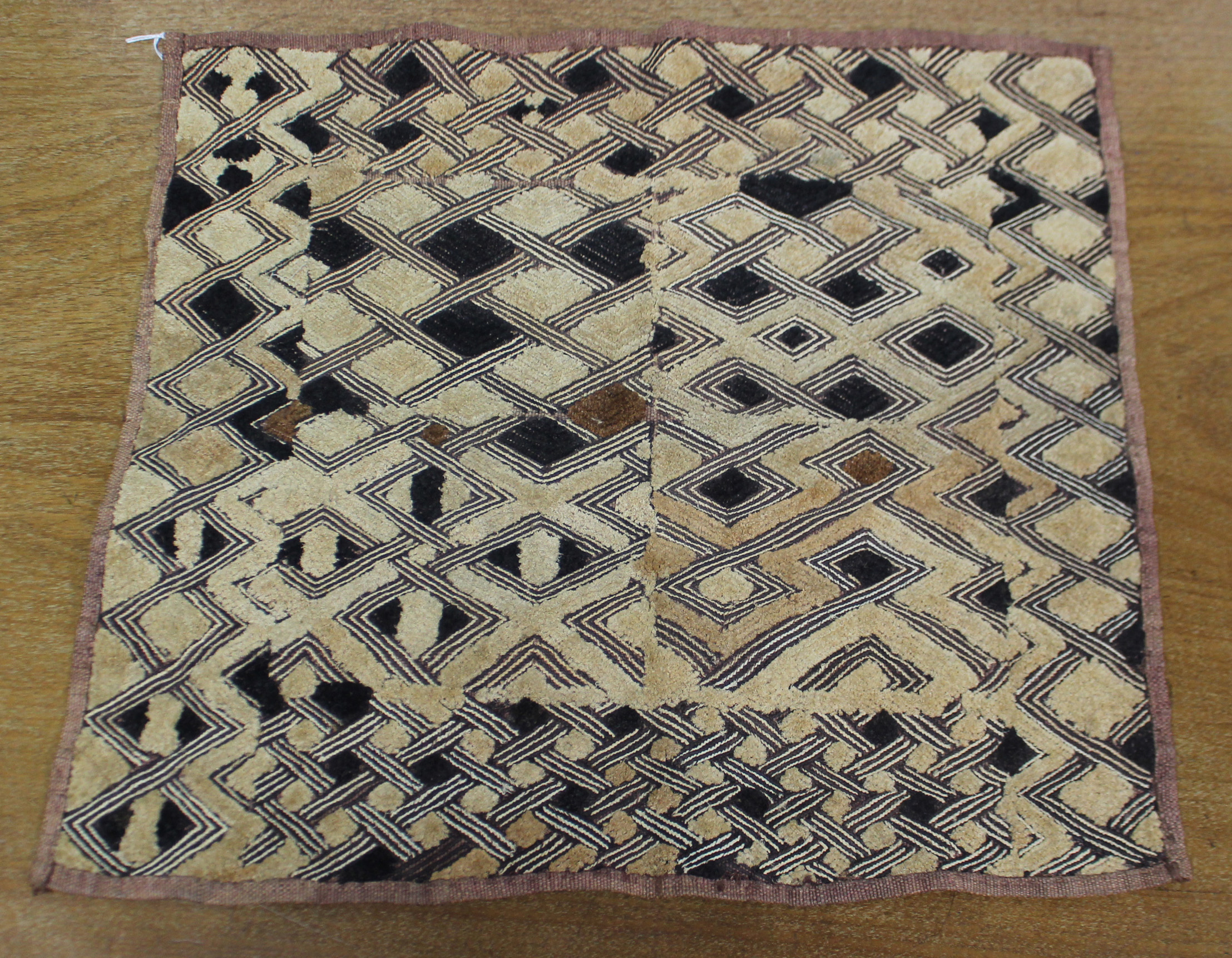 A Kuba cloth panel, the dark brown field with decorative trellis-pattern stitching & applied small - Image 2 of 7