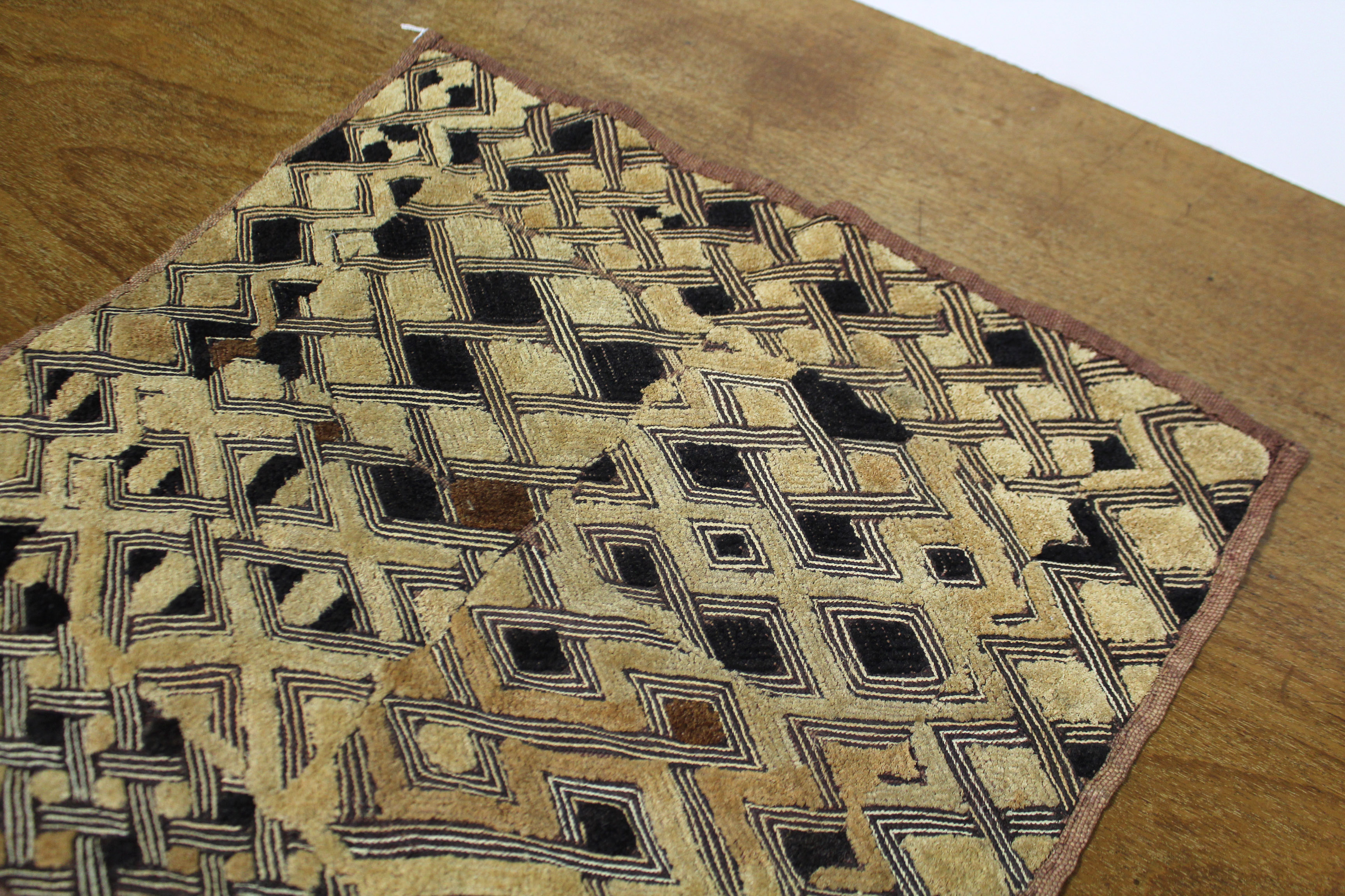 A Kuba cloth panel, the dark brown field with decorative trellis-pattern stitching & applied small - Image 6 of 7