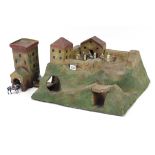 A papier-mâché toy fort, 20” wide; & eleven various painted lead knight figures.