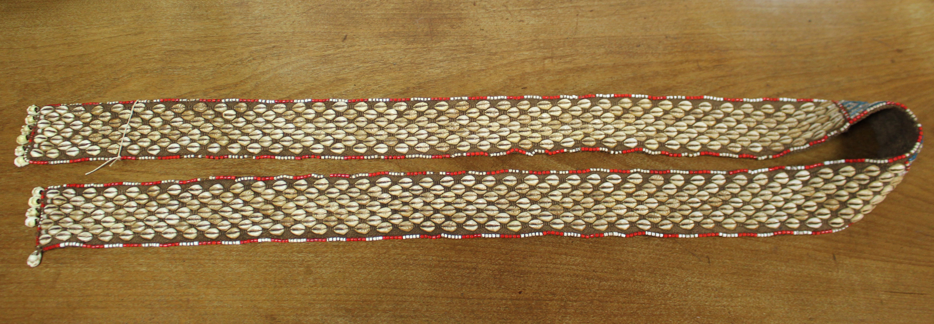 A Kuba woven raffia long belt with diagonal rows of applied cowrie shells either side of a central - Image 5 of 6