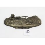 A French cast-metal novelty inkstand in the form of a soldier holding a machine gun in a trench,