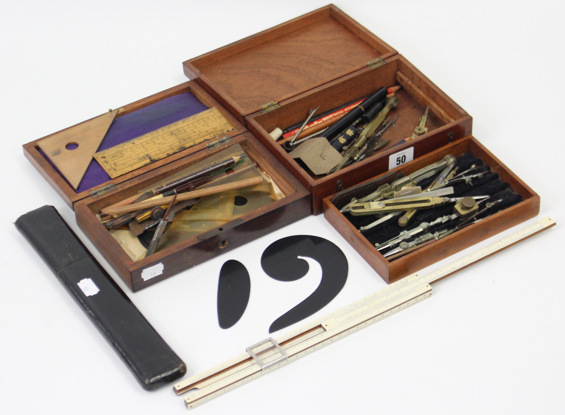 Two part-sets of drawing implements, each part set in a fitted case; & a Bavarian slide rule,