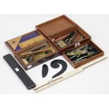 Two part-sets of drawing implements, each part set in a fitted case; & a Bavarian slide rule,