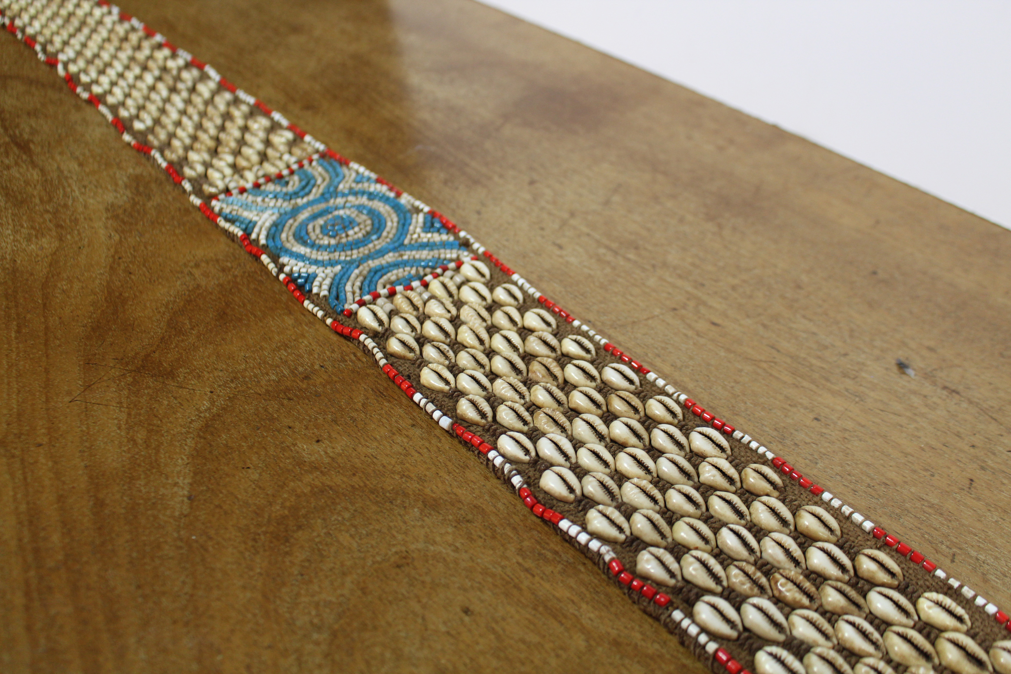 A Kuba woven raffia long belt with diagonal rows of applied cowrie shells either side of a central - Image 3 of 6
