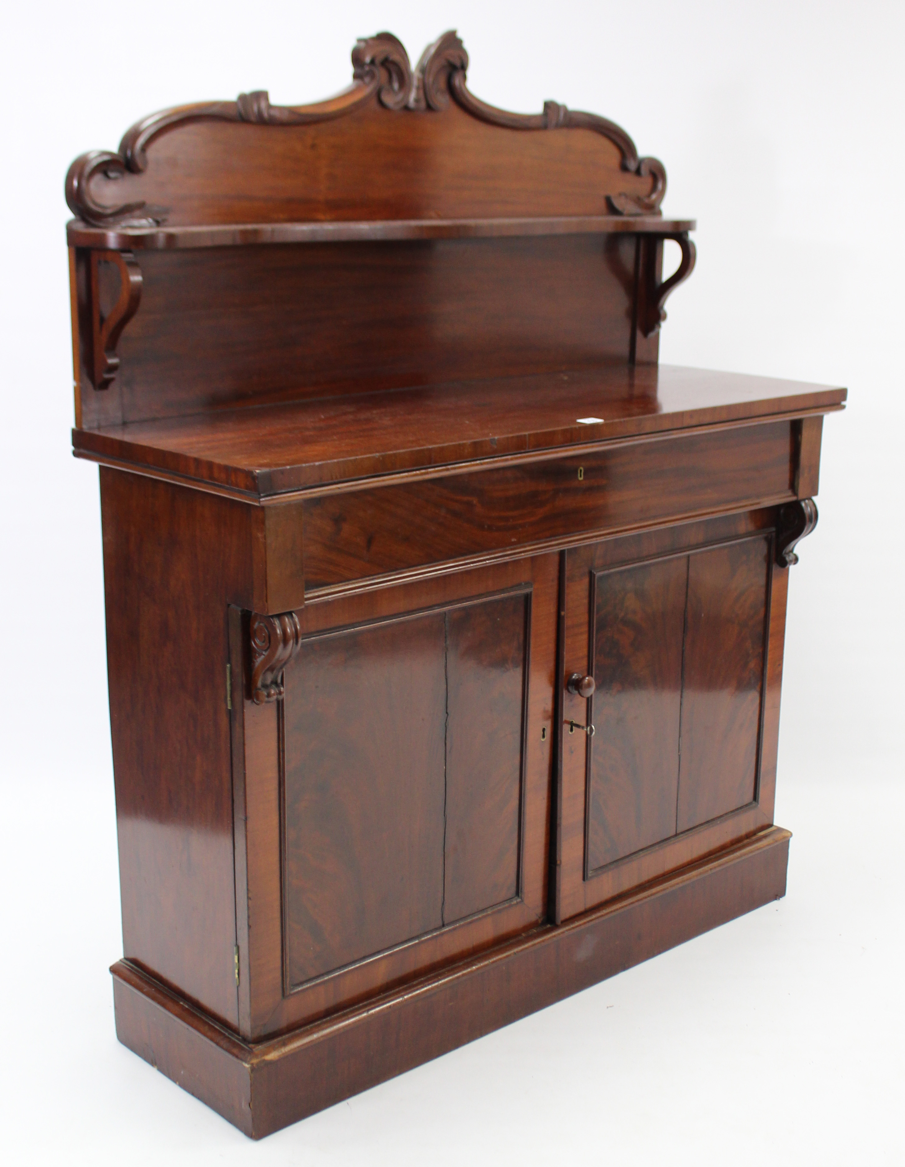 A Victorian mahogany chiffonier with open shelf to the low-stage panel back, fitted frieze drawer