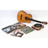 A six string acoustic guitar; & approximately eighty various records.