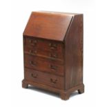 An early 20th century small oak bureau, with fitted interior enclosed by fall front above four