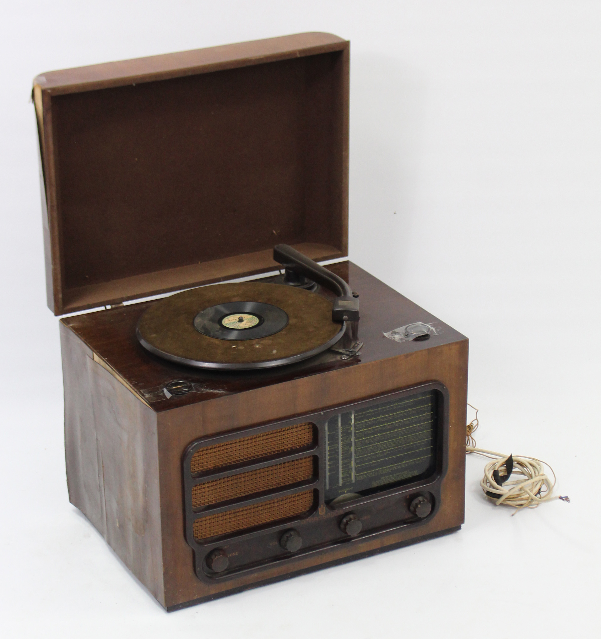 An Ambassador radiogram in mahogany-finish case; together with various books.