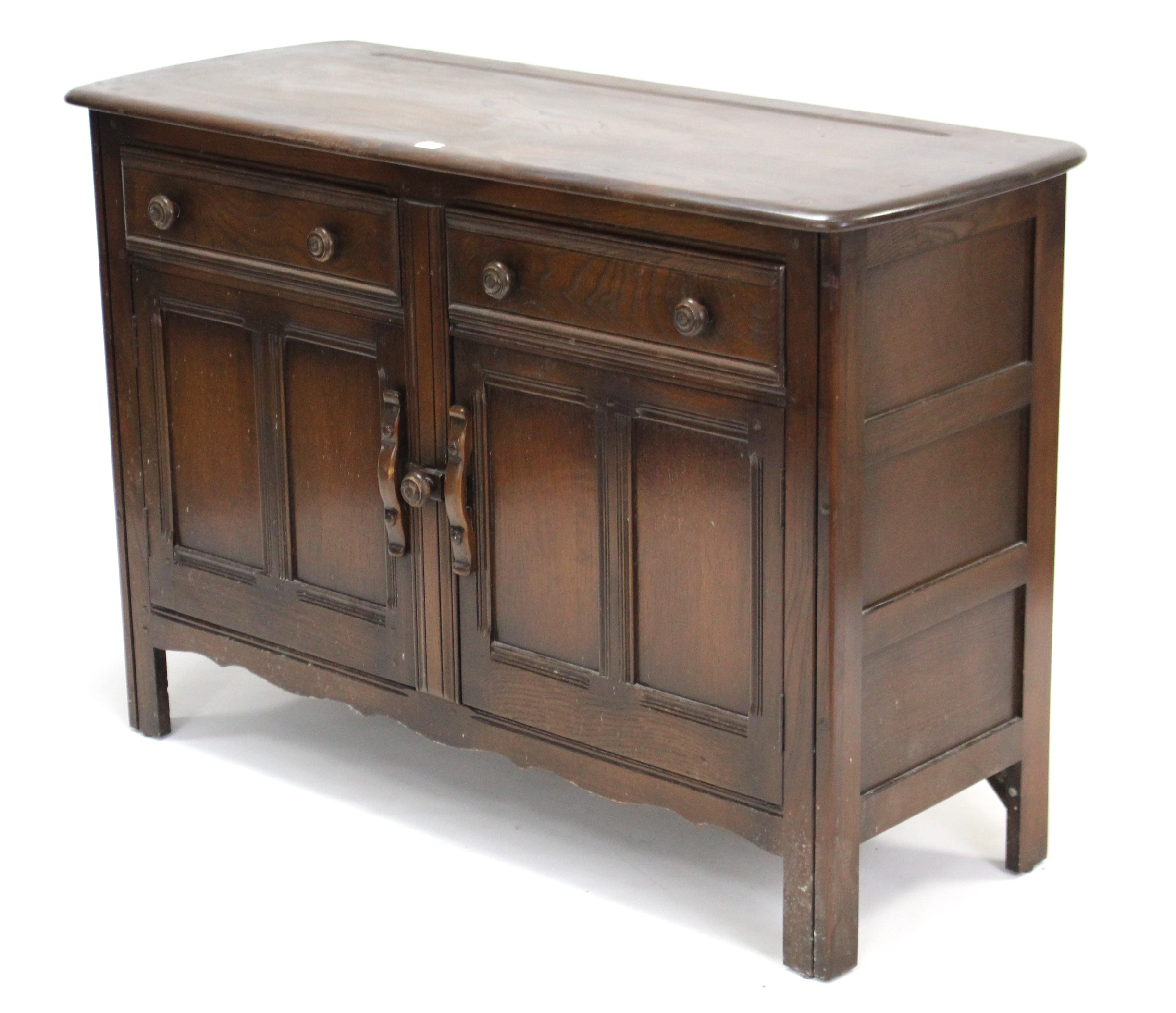 An Ercol dark elm sideboard fitted two frieze drawers above cupboard enclosed by pair of panel