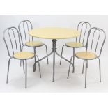 A silvered-metal kitchen table on four shaped legs & with woodgrain-effect circular top, 35½” diam.;