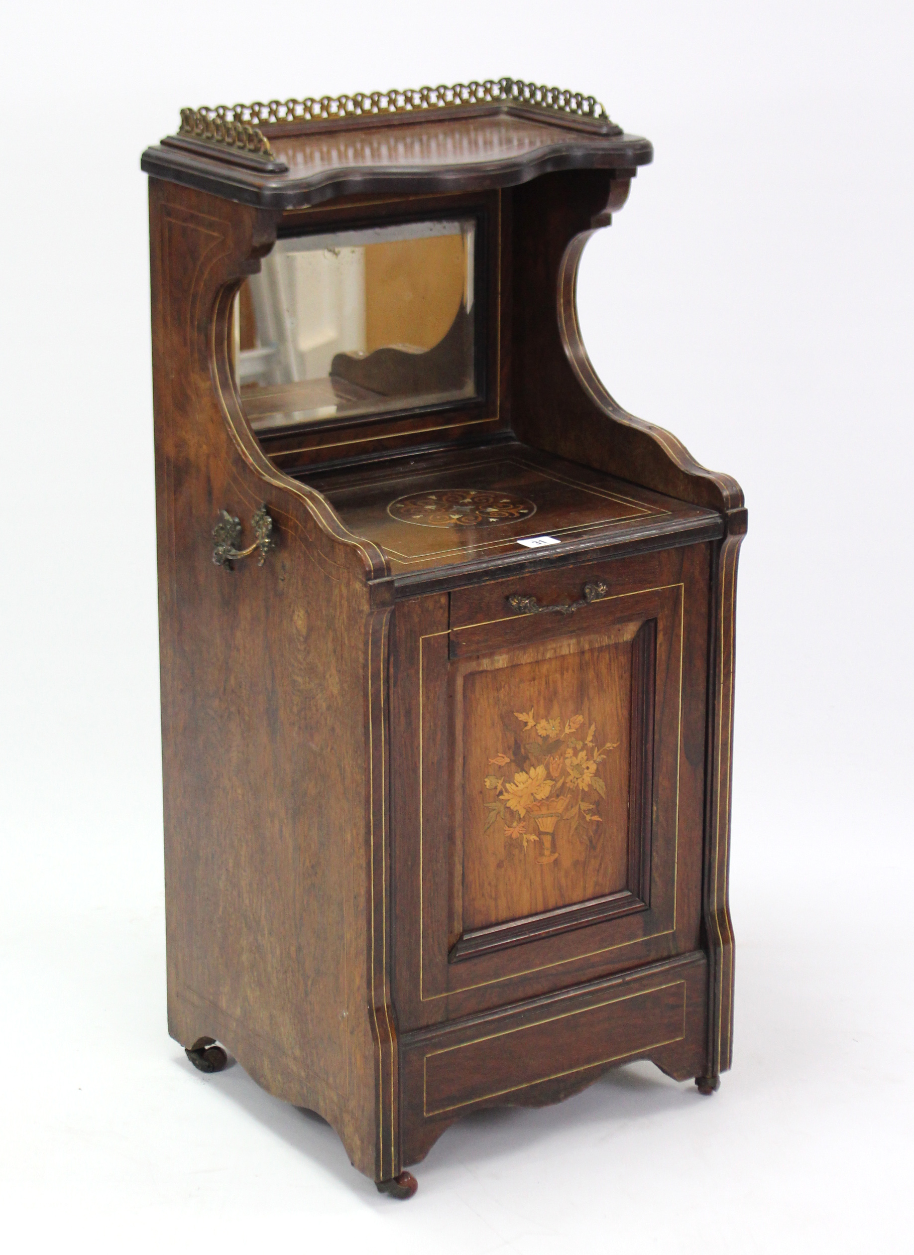 A 19th century inlaid-rosewood purdonium enclosed by fall-front panel door, & on ceramic castors,