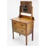 A small oak dressing chest with rectangular swing mirror to the stage back, fitted two long