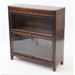 A mahogany Globe Wernicke-type two-tier sectional bookcase, each tier enclosed by glazed door & on