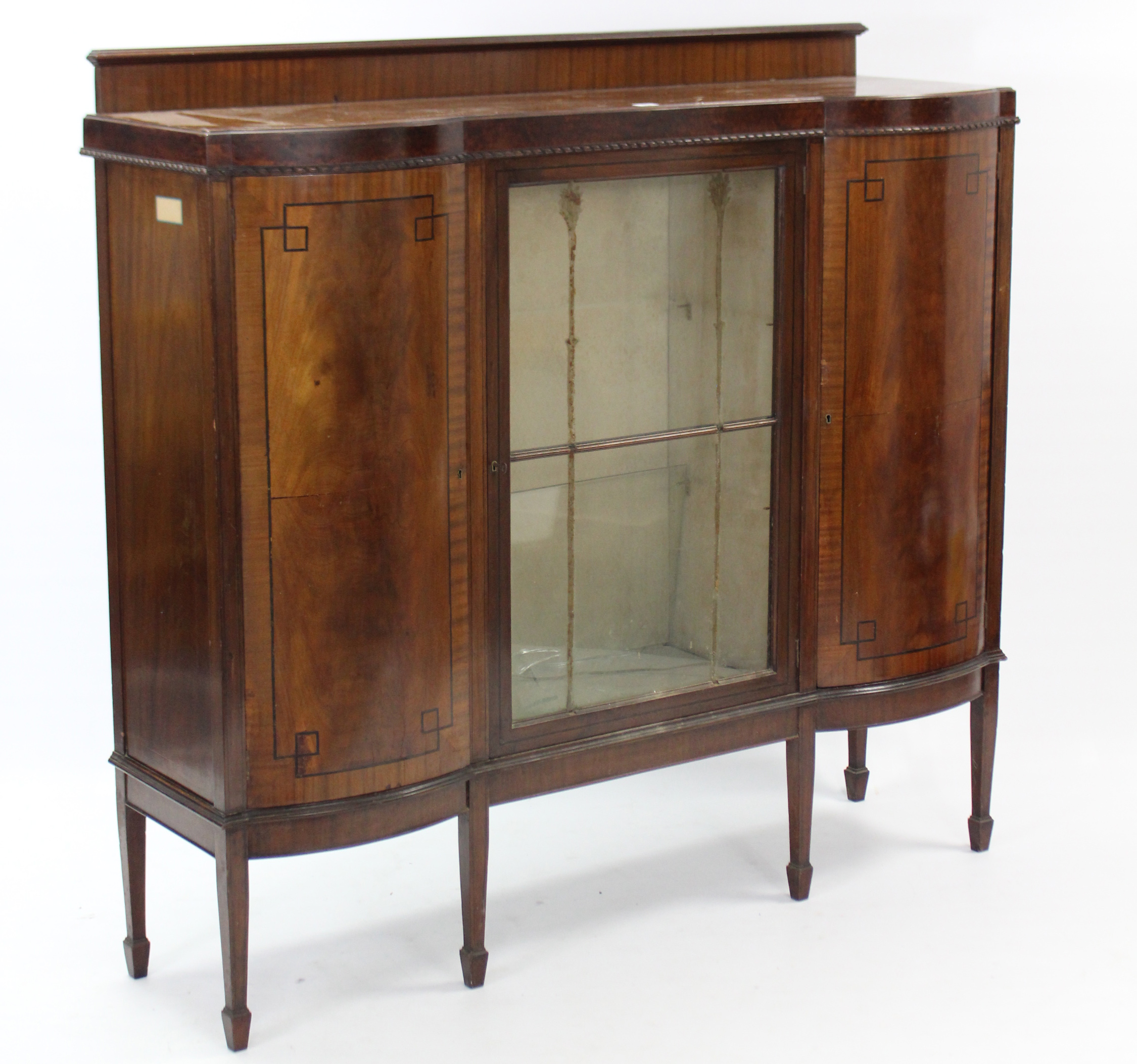 An Edwardian inlaid-mahogany inverted break-front china display cabinet, fitted plate-glass shelf to