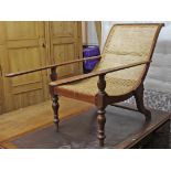 A teak plantation chair inset woven-cane panel to the all-in-one seat & back, & on baluster-turned