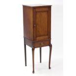 An Edwardian inlaid-mahogany small upright cabinet with fitted interior enclosed by panel door above