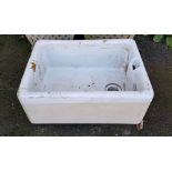 A white-glazed Belfast sink, 23½” x 9½”.