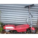 A child's electric scooter in red-finish case.
