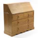 A pine bureau with fitted interior enclosed by fall-front above two short & two long graduated