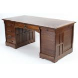 AN EARLY 20th CENTURY OAK KNEEHOLE OFFICE DESK, inset brown leather to the rectangular top, fitted