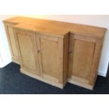 A Victorian pine break-front sideboard with fitted interior enclosed by two pairs of panel