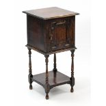 A 1930’s oak bedside cabinet enclosed by panel door with open shelf below, & on baluster-turned