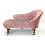 A Victorian small chaise longue upholstered buttoned pink velour, & on walnut turned legs with brass