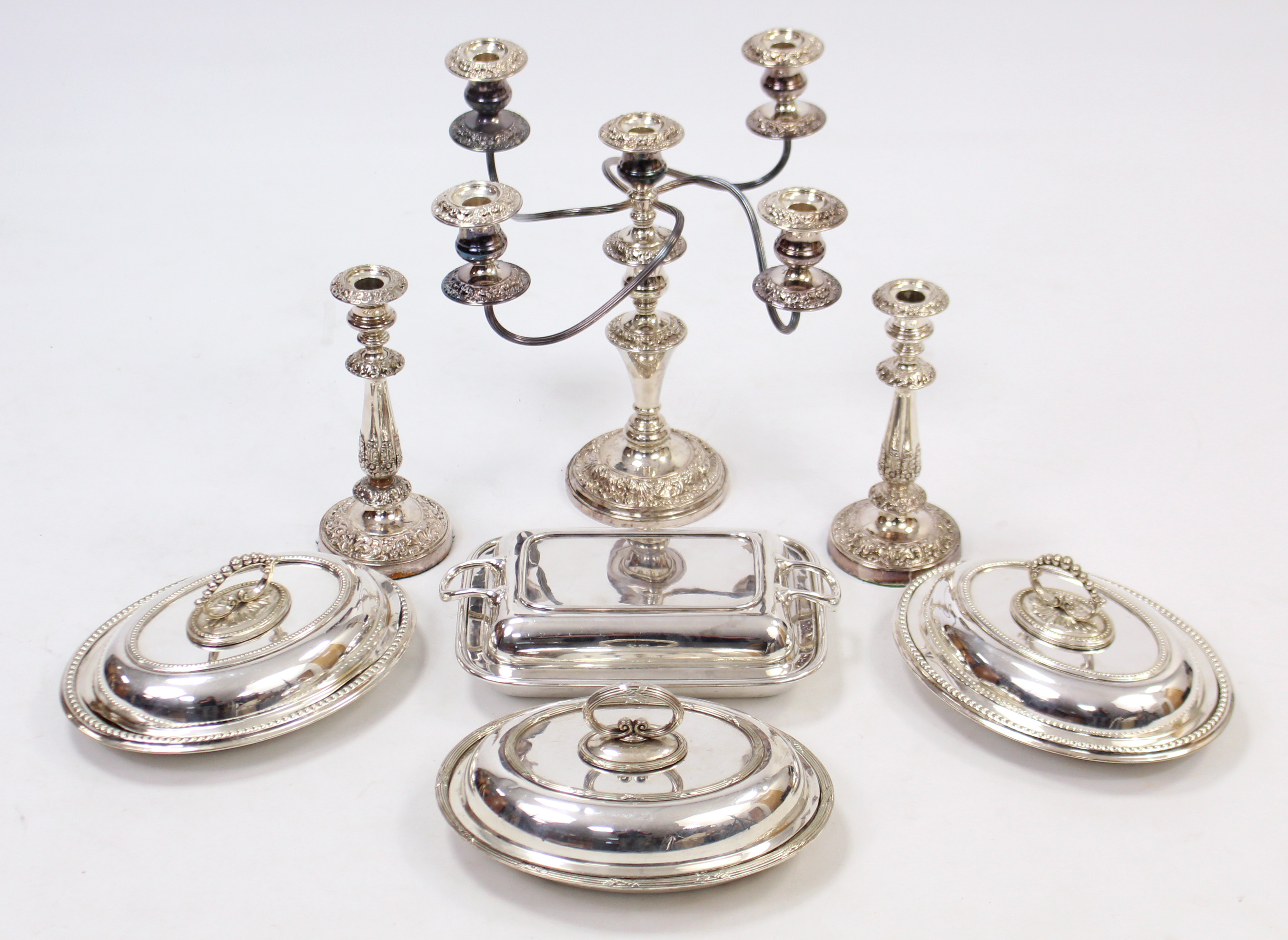 A silver plated four-branch table candelabra, 13½” high; a ditto pair of candlesticks, 9” high; &