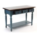 A turquoise painted & natural hardwood side table, fitted three frieze drawers & on baluster-