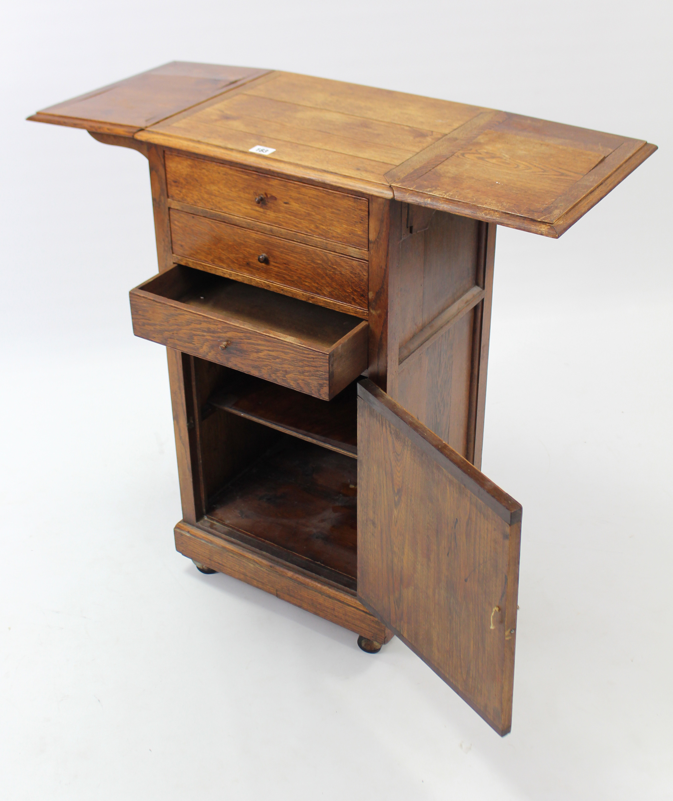 An early 20th century oak drop-leaf bedside cabinet fitted three long drawers above cupboard - Image 5 of 6